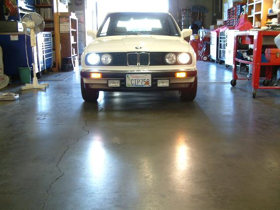 BMW H7/HID kit Installed on the left, compared to the H7 on the right.